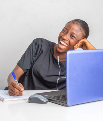 Student Smiling at Laptop